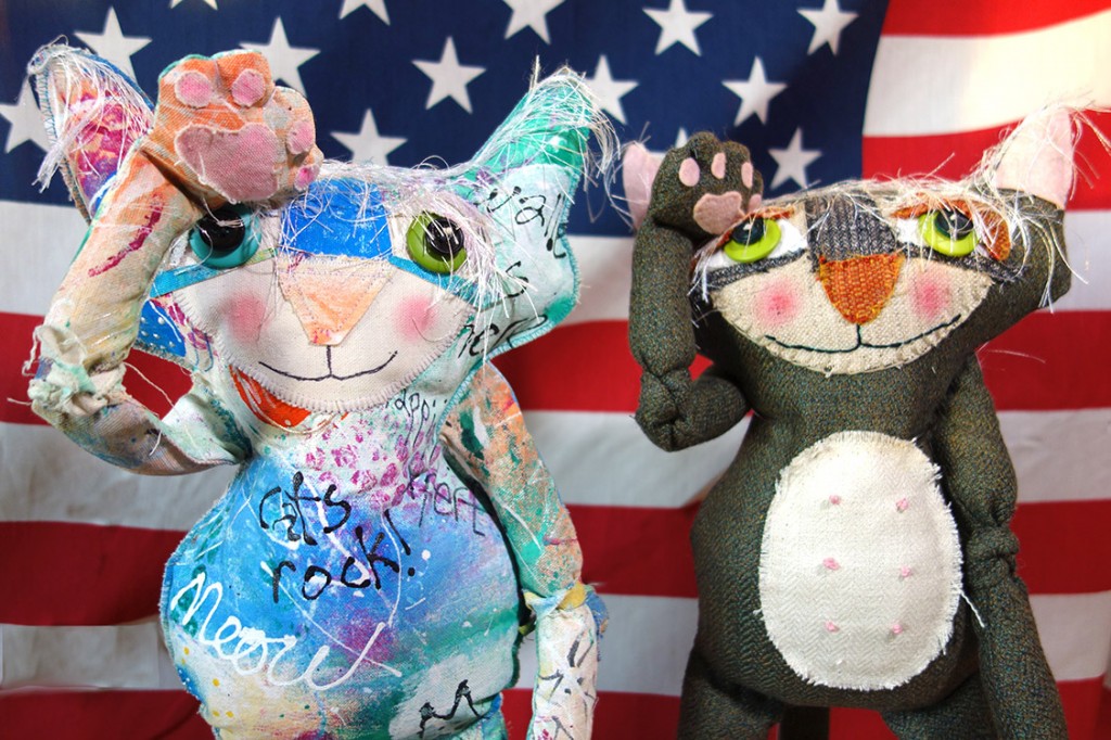 Two whimsical cat dolls salute the veterans on this holiday.