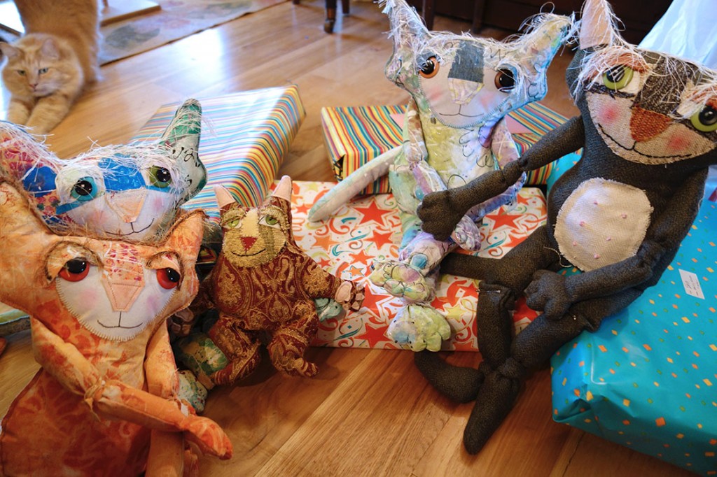 Whimsical Cat Dolls sitting around wrapped birthday boxes.