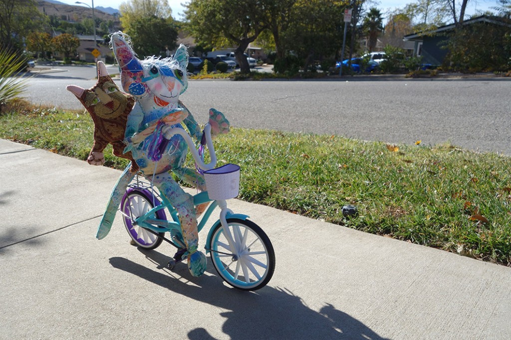 The Chairman and his cat on the bike peddling up hill to the next door neighbor.