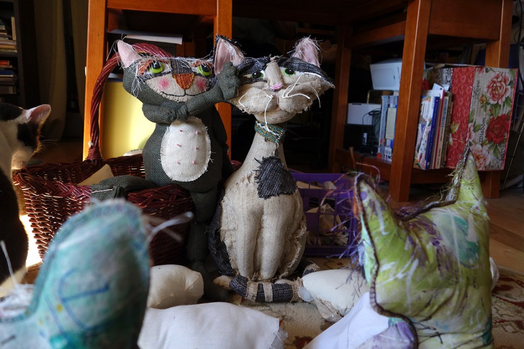 A beautiful, tall soft sculptured cat doll made out of an old suit.