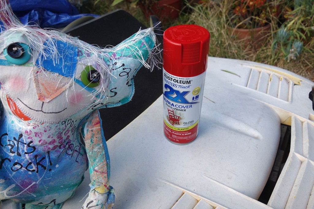 The Chairman poses with a can of Candy Apple Red spray paint on the hood of his  car.