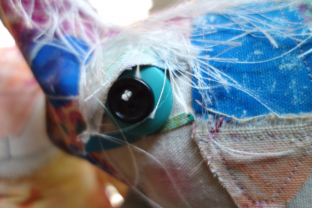 Extreme closeup of soft-sculptured cat doll, The Chairman.