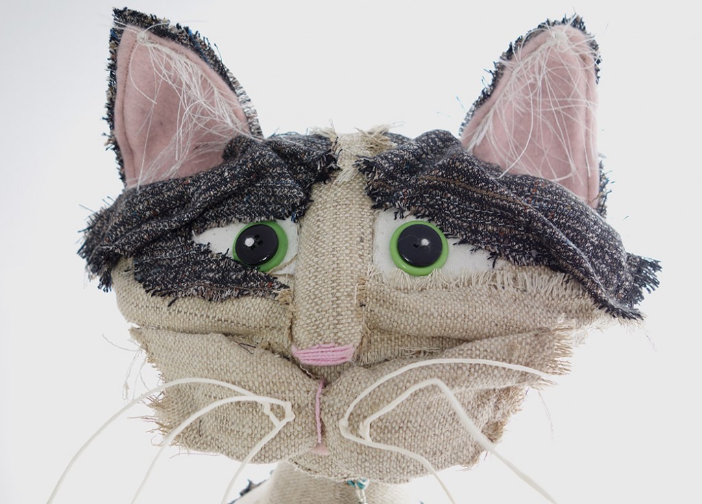 Head shot of beautiful art doll. His features are folded and sculpted from an old wool suit.