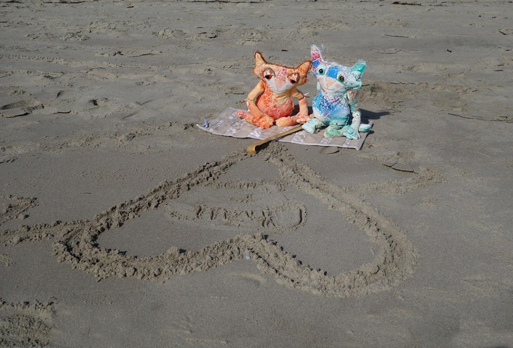 The Chairman and Ginger sitting in the sun on their beach blanket.