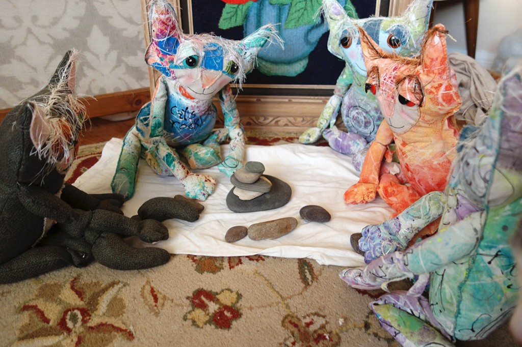 The cat doll community is stacking flat rocks collected from the ocean. They're doing a pretty good job!