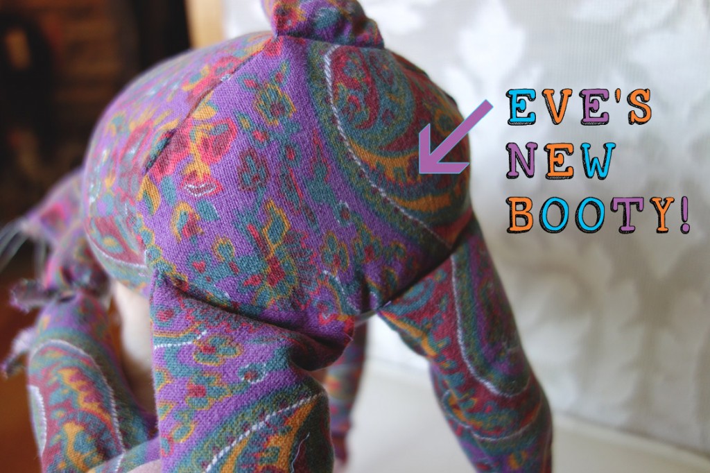 A photo showing the revised bottom for the cats so that the sit better. Colorful lettering states that this is Eve's New Booty!