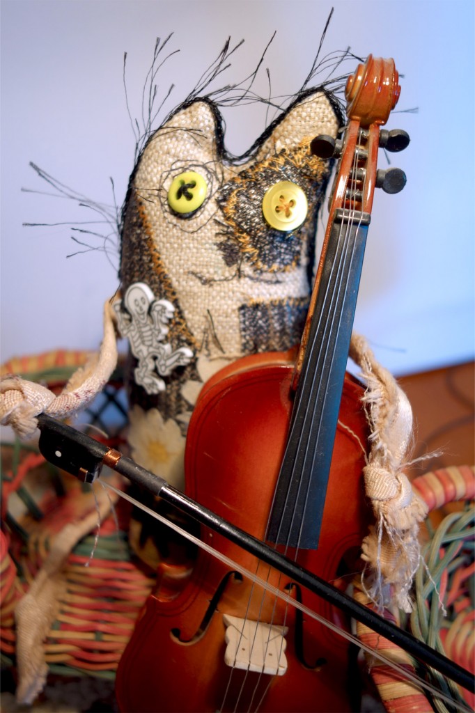 Frankencat continues playing the cello.