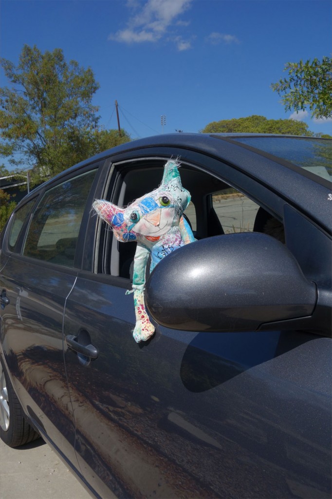 The Chairman sticks his head out the car window.