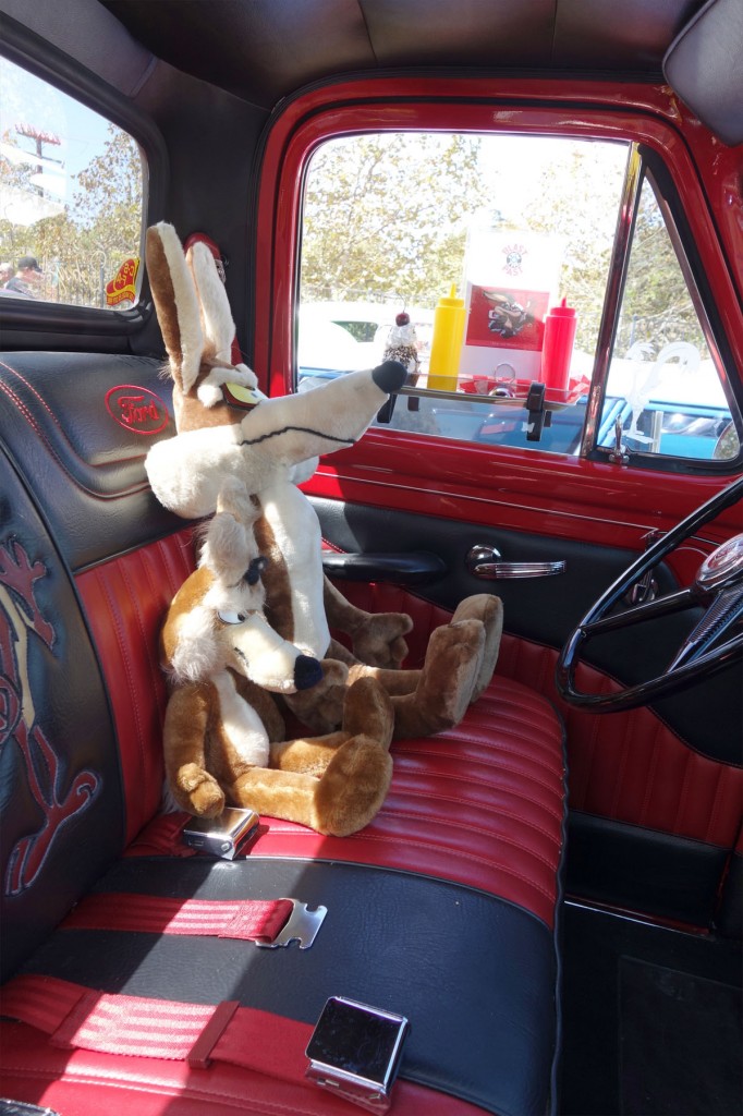 Two Roadrunner dolls sitting inside the most awsome vintage pickup truck.