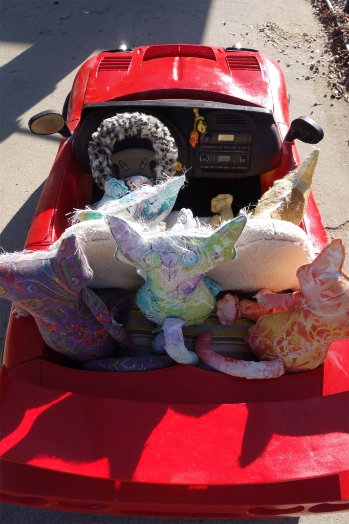 The Chairman and his gang sitting in a little red corvette.