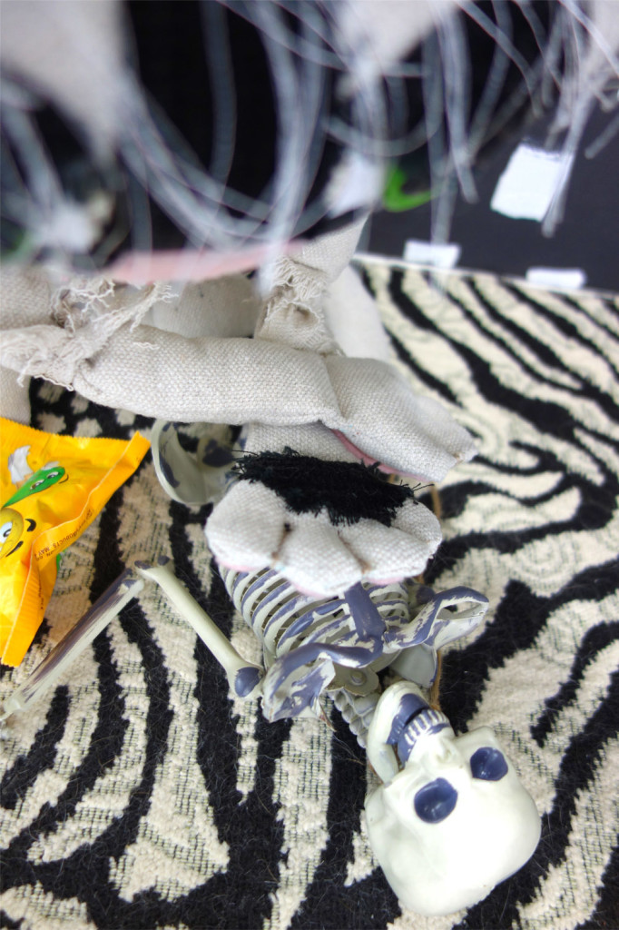 An up close shot of Bandit's paws on the chest of the passed out skeleton.