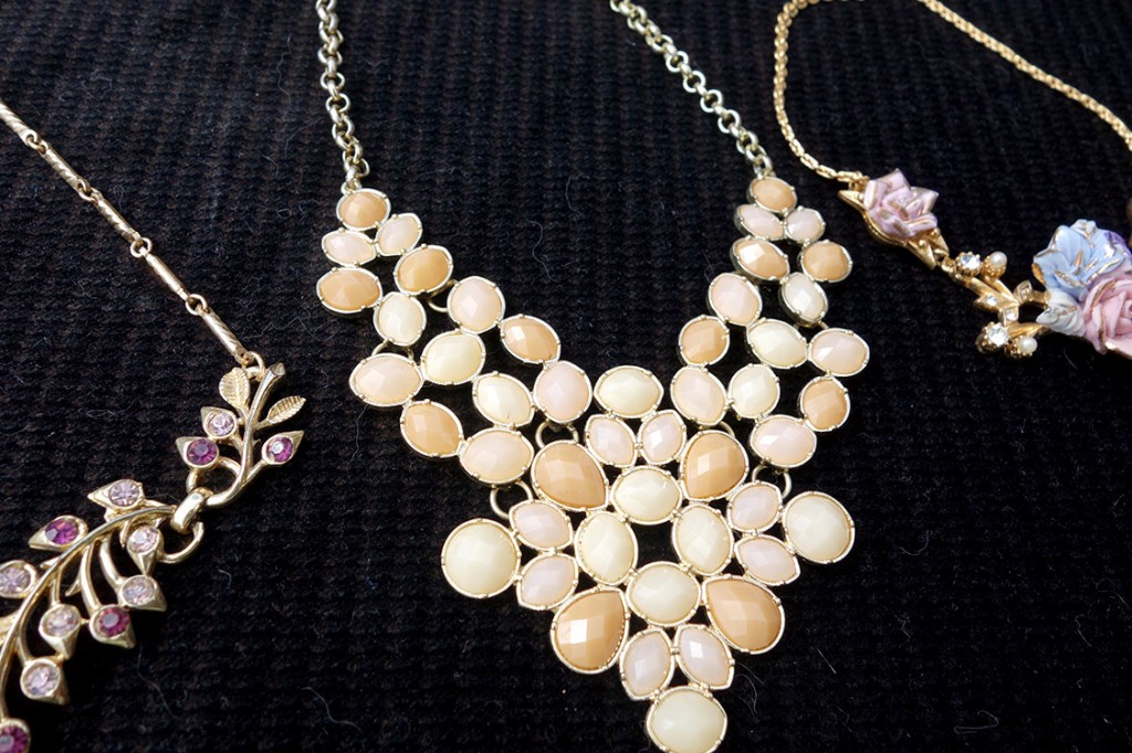 Lovely costume jewelry spread out dramatically on a black velvet background.