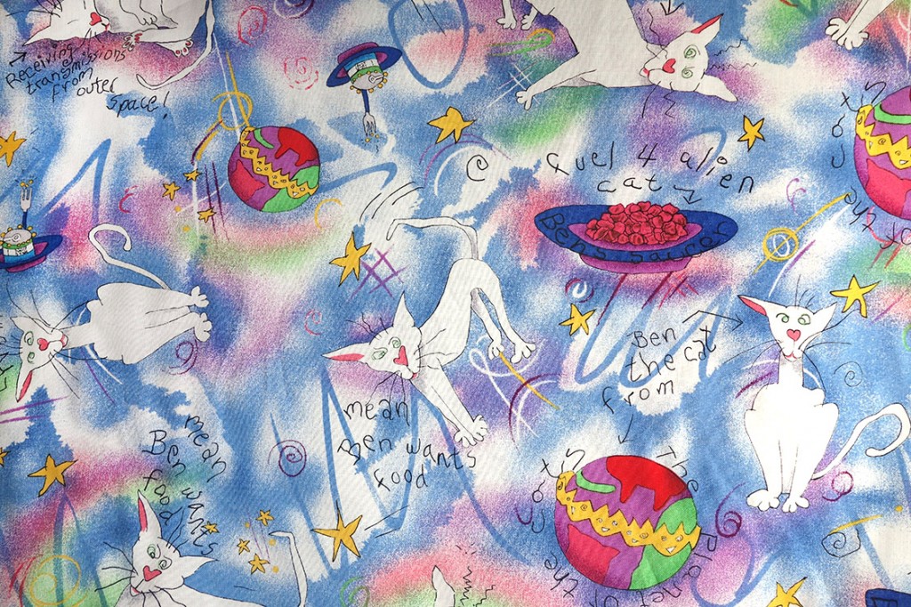 A photograph of the fabric featuring Ben, the cat from outer space