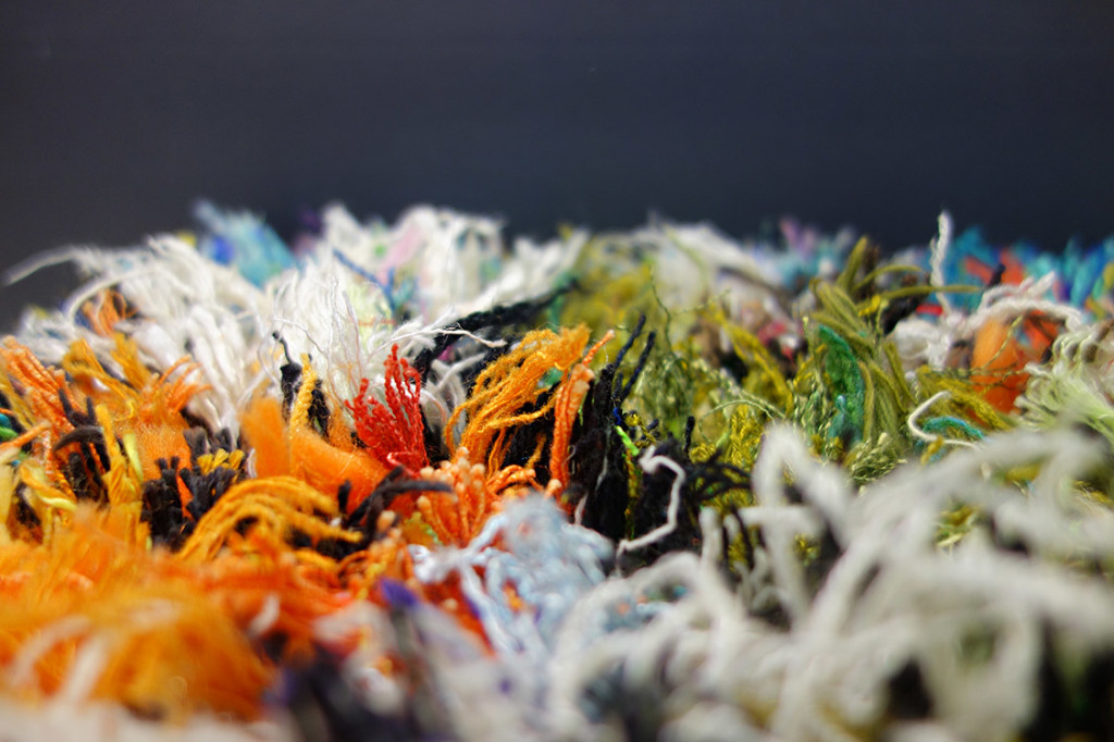 A closeup of the colorful shag rug making it look like terrain on an alien planet.