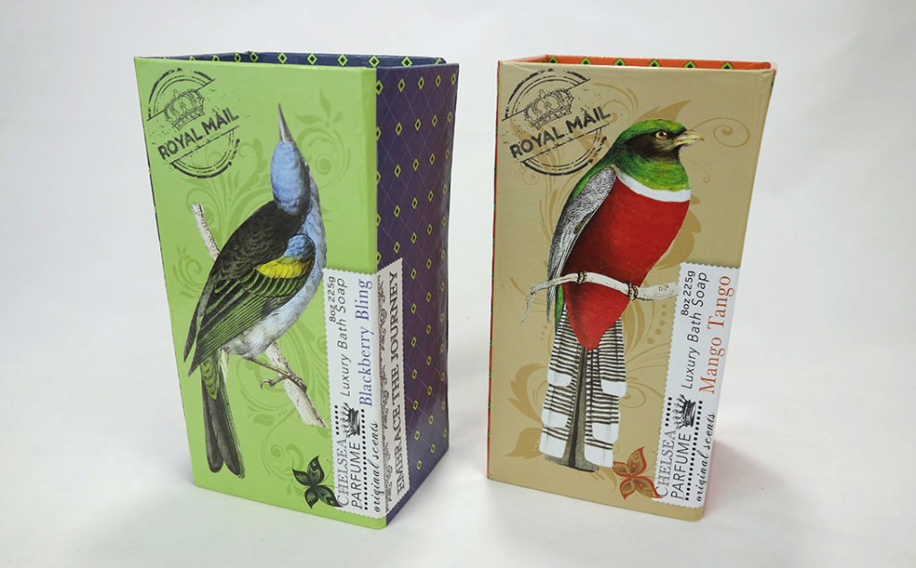 Two single bar soap boxes brightly decorated with colorful birds and geometric prints.