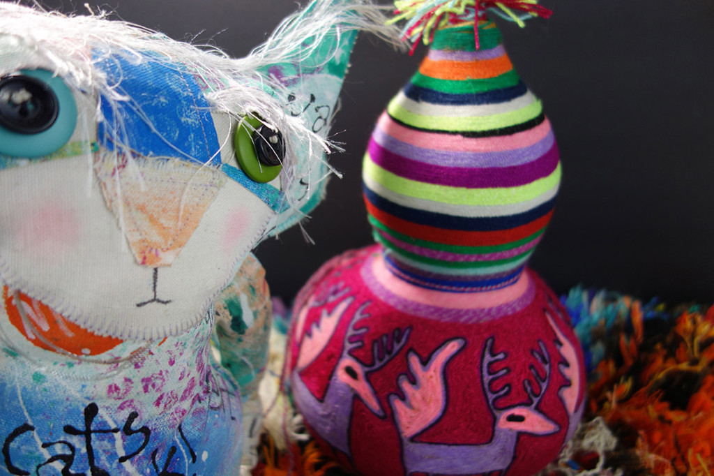 The Chairman is pictured with a very colorful gourd covered in yarn. He is not smiling.