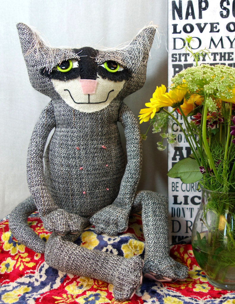 A soft sculpture cat made from an upcycled mans suit. His name is Cooper.