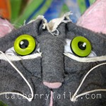 Closeup of the new gray magnificat with adorable button eyes and fabric sculpted face.